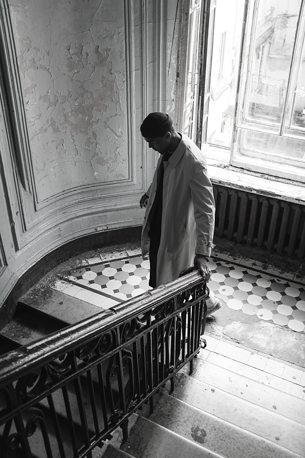 Man in White Thobe Standing on Brown Wooden Staircase